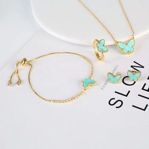 Elegant gold butterfly jewelry set with mint green enamel and sparkling zircon accents