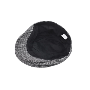 British style men's flat cap with black and white herringbone pattern and inner lining