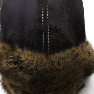 Detail of leather texture and thick faux fur trim with stitching on winter aviator hat