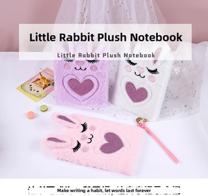 Detail view of plush bunny notebooks with 3D ears and sequin heart embroidery