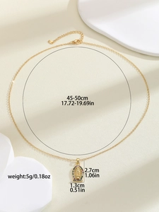 Detail view of Virgin Mary pendant with colorful zircons and size measurement labels