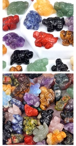 Macro shot of assorted carved gemstone turtles in colorful amethyst and agate crystal
