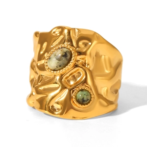 Detail of hammered gold stainless steel ring with two natural green tiger eye stones