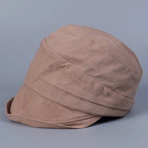 Detail of a brown newsboy cap with textured pleats and soft cotton-linen fabric