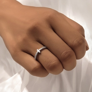Detail of S925 sterling silver cross ring featuring sparkling pave zircons on woman's hand