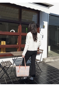 Detailed back view of pink plaid tote bag styled with a white tweed jacket outfit