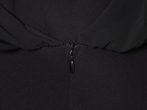 Close-up of invisible zipper and woven fabric texture on black georgette jumpsuit