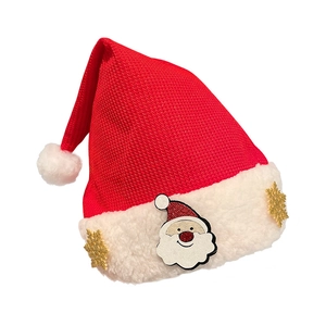 Knitted red Christmas hat with plush trim featuring Santa and golden snowflake patches