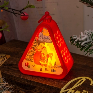 Macro shot of red Christmas lantern with Santa pattern on a wooden festive table