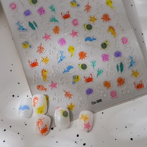 3D embossed sea animal nail stickers featuring colorful crabs and shells on white nails