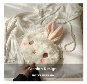 Detail showing plush rabbit bag with soft faux fur texture and elegant pearl strap