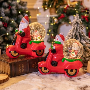 Boules à neige Père Noël à moto sur livres anciens pour décoration de Noël festive