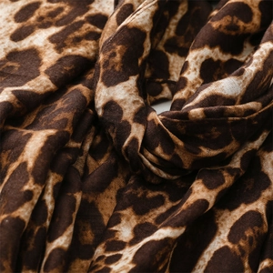 Macro shot of breathable leopard print fabric with classic brown and beige patterns