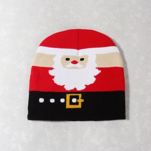 Detailed close-up of a red knitted Christmas hat featuring a classic Santa Claus pattern