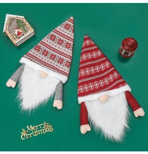 Detail of plush faceless gnome tree toppers with knitted snowflake patterns and long beards