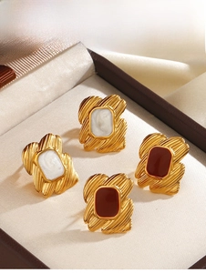 Detail view of 18K gold plated rectangular earrings with white and red enamel finish