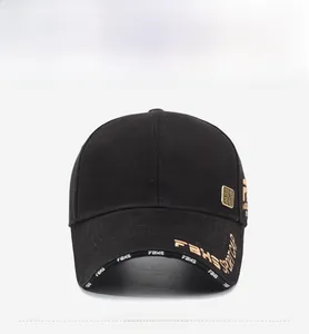 Detail of black baseball cap with gold FBKS embroidery and metallic accents