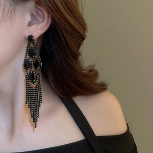 Close-up of black rhinestone waterdrop tassel earrings worn on model for party
