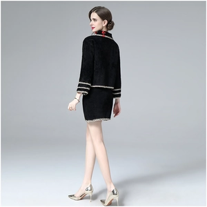 Detail view of black faux mink wool jacket and skirt set with elegant woven contrast trim
