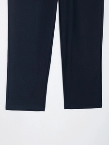 Close-up detail of dark blue trousers featuring high-quality fine twill fabric texture