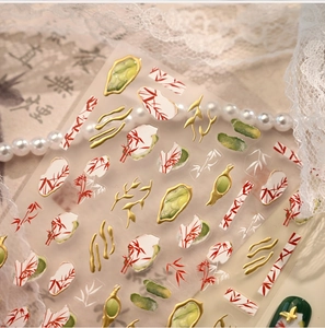 Macro detail of Chinese ink style nail stickers with red bamboo and gold embossed textures