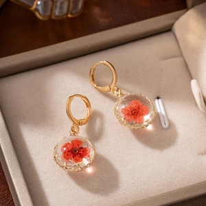 Handmade gold flower earrings with real red dried flowers inside clear glass balls