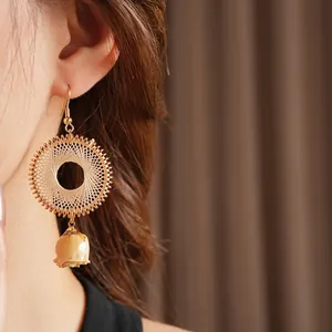 Bohemian woven gold hoop earrings with preserved yellow rose buds for a vintage summer look