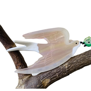 Elegant swallow bird hair claw clip in pearlescent acetate finish on a branch