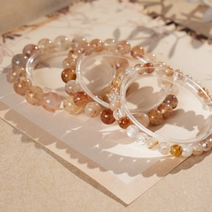 Detail of red rutilated quartz beaded bracelets with natural hair-like crystal inclusions
