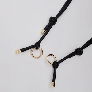 Detail of 6mm black leather cord with gold metal end caps and spring ring clasp