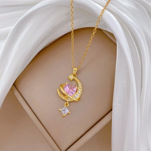 Luxurious gold necklace with pink heart zircon and moon pendant on white silk