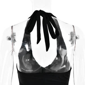 Detail view of the halter neck tie and open back design on a black stretch maxi dress