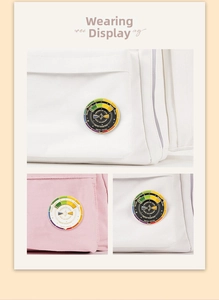 Wearing display of black and white spinning color wheel enamel pins on canvas bags