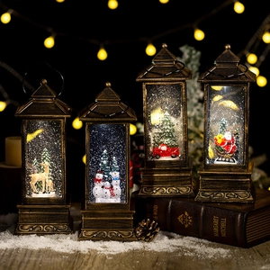 Vintage Christmas snow globe lanterns with Santa and reindeer scenes on a festive table