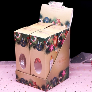Close-up of festive Christmas gift boxes with transparent windows on display rack