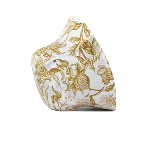 Close-up of white bucket hat with golden floral print and detailed stitching on brim