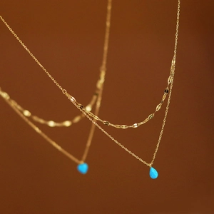 Double-layer stainless steel gold necklace featuring a blue water drop opal pendant