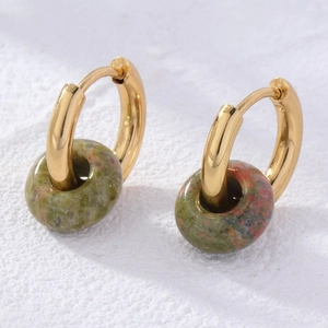 Detail of gold hoop earrings with green and red marbled natural stone beads