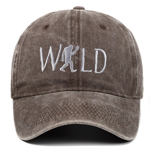 Detail of WILD embroidery with bigfoot silhouette on washed distressed canvas baseball cap