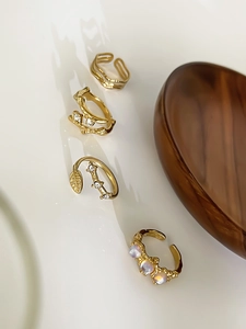Detail view of a 4-piece vintage gold adjustable ring set with moonstone and cubic zirconia