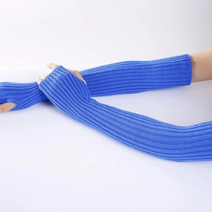 Detailed view of blue ribbed knit arm warmers with thumb holes on a white background