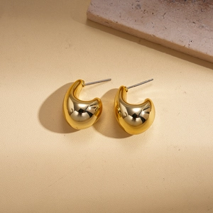 Detail shot of chunky 18K gold plated teardrop stud earrings with mirror polished finish