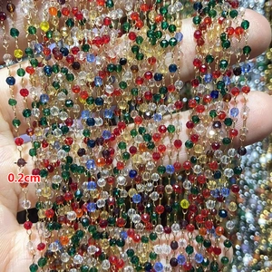 Detailed macro view of 2mm colorful crystal bead chain with golden stainless steel links