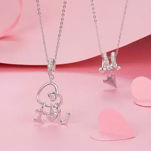 Romantic 925 sterling silver heart pendants with pink gemstones on a soft pink background
