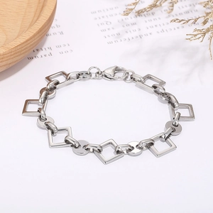 Detail view of silver stainless steel geometric bracelet with square and round links