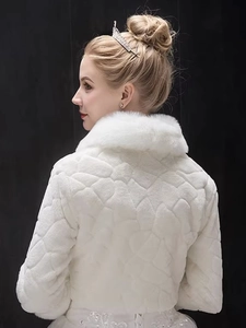 Detail of elegant white faux fur bridal shawl with soft texture for wedding gowns