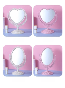 Detail view of retro baroque heart and oval vanity mirrors in white and pink