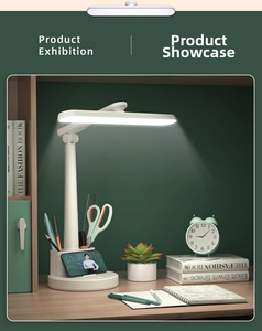Detail of white LED desk lamp featuring adjustable arm and built-in pen holder on desk