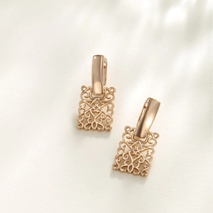 Elegant rose gold hollow geometric earrings with vintage patterns on a white background