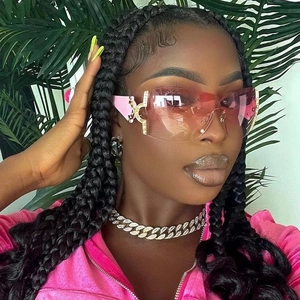 Close-up of pink gradient Y2K shield sunglasses with rhinestones on fashion model